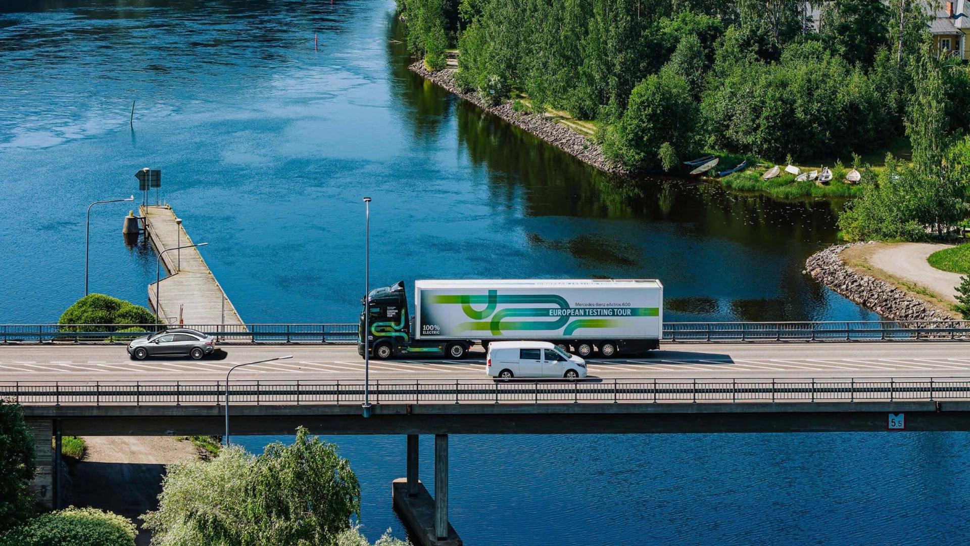 Mercedes-Benz kuorma-auto, pakettiauto ja henkilöauto sillalla ajamassa Saimaa-järven yli